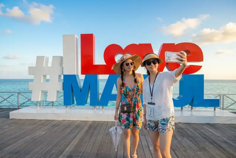 Iconic photo spot at the I Love Mabul sign on Mabul Island Cupid Resort