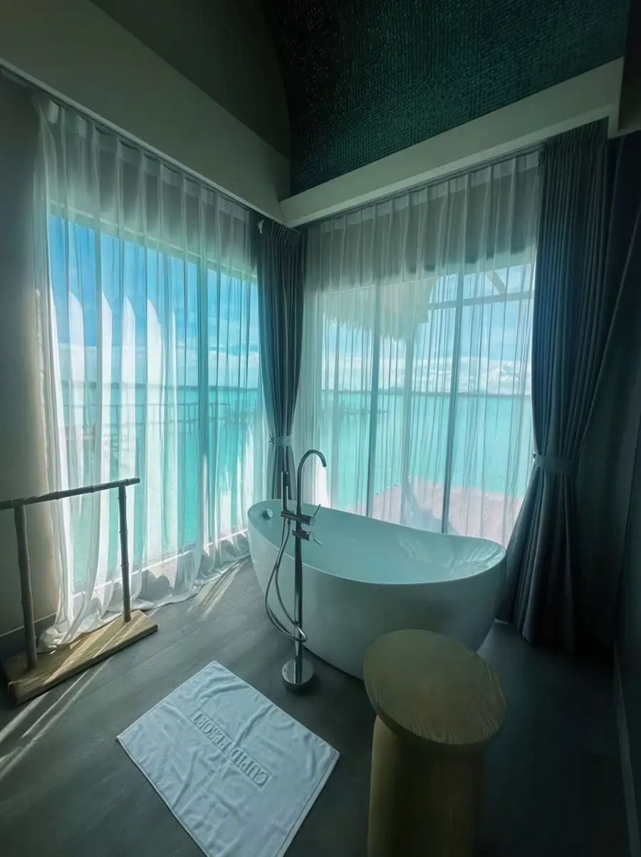 Contemporary soaking tub positioned over the turquoise Celebes Sea at Cupid Resort, Semporna.