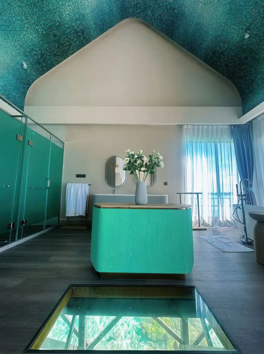 A modern bedroom at Cupid Resort in Semporna featuring glass floor panels, a designer vanity, gleaming timber floors, and air conditioning.