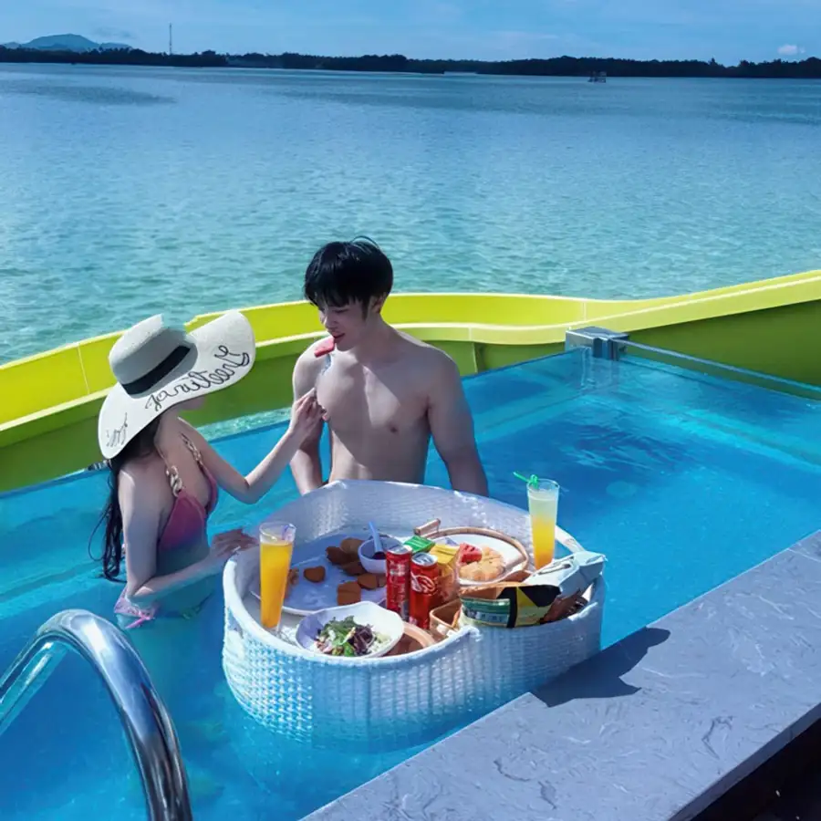 Guest enjoying the ocean breeze from a private glass-front plunge pool at Cupid Resort, Semporna.