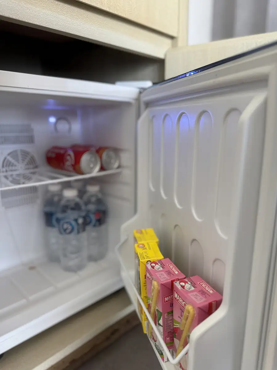 In-room mini fridge stocked with refreshments at Cupid Resort, Semporna.
