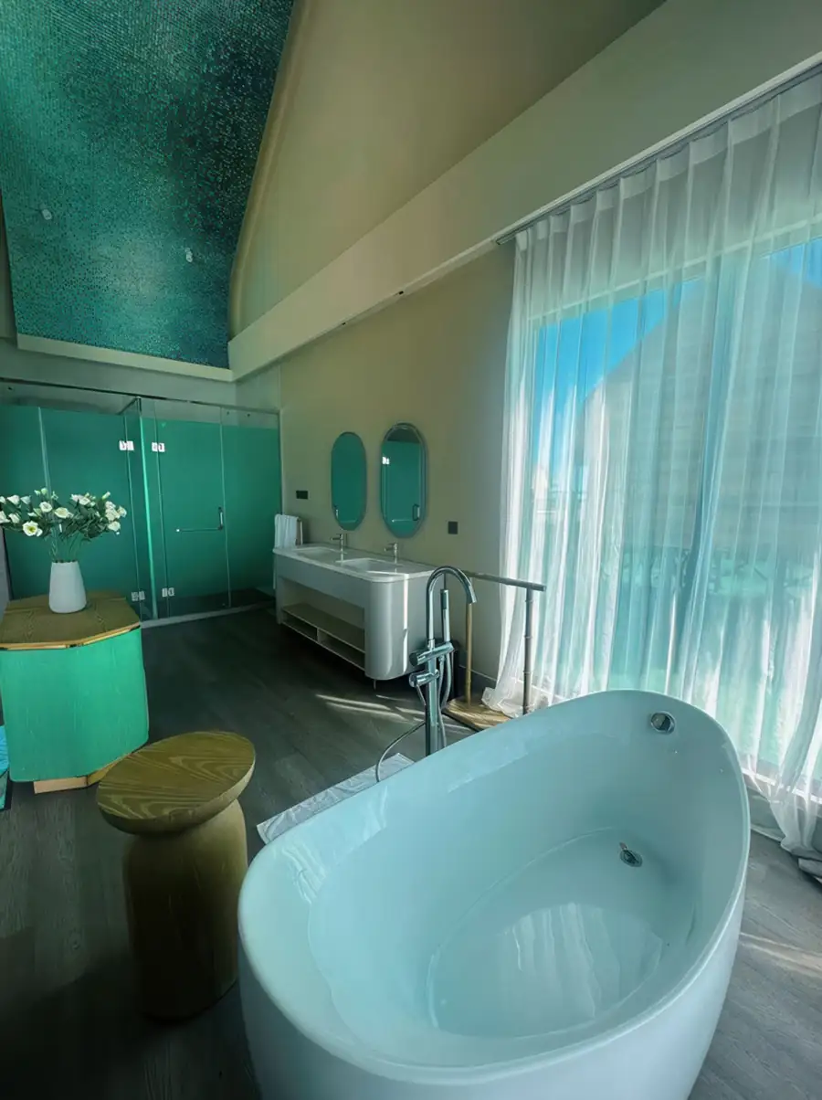 Spacious ocean suite bathroom with modern fixtures and sea views at Cupid Resort.